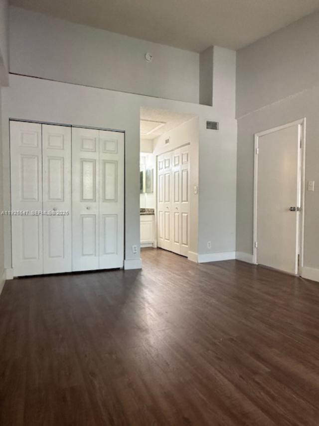 921 Lyons Road, Unit 3205 Coconut Creek, FL 33063 - Photo 19 of 37 an empty room with wooden floor & windows