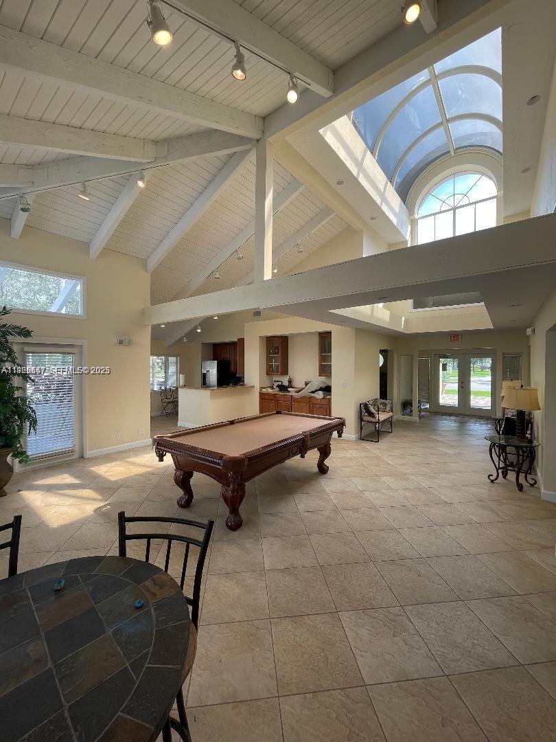 921 Lyons Road, Unit 3205 Coconut Creek, FL 33063 - Photo 26 of 37 a living room with furniture and a table