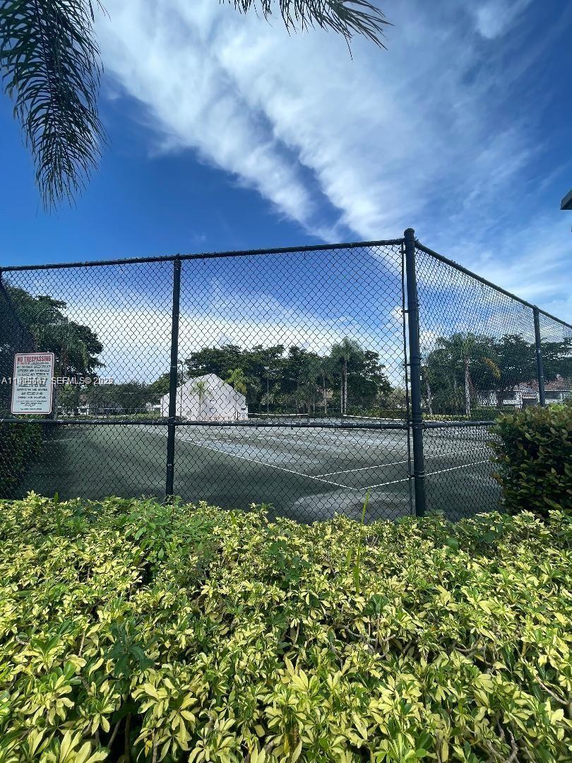 921 Lyons Road, Unit 3205 Coconut Creek, FL 33063 - Photo 32 of 37 a view of a street with a yard