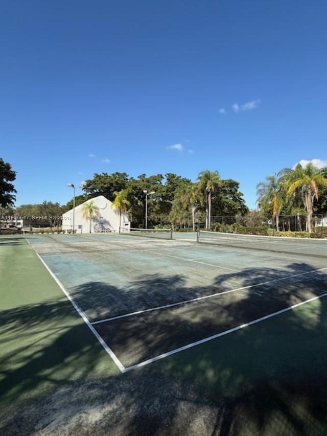 921 Lyons Road, Unit 3205 Coconut Creek, FL 33063 - Photo 33 of 37 a view of a tennis court