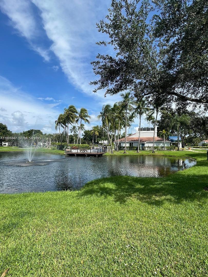 921 Lyons Road, Unit 3205 Coconut Creek, FL 33063 - Photo 35 of 37 a view of a lake with houses in the background