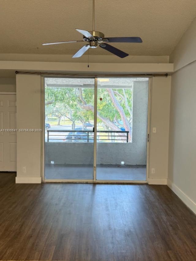 921 Lyons Road, Unit 3205 Coconut Creek, FL 33063 - Photo 4 of 37 a view of empty room with wooden floor and fan