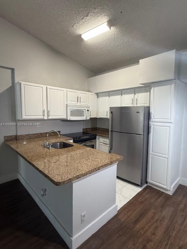 921 Lyons Road, Unit 3205 Coconut Creek, FL 33063 - Photo 5 of 37 a kitchen with kitchen island a counter top space cabinets and stainless steel appliances