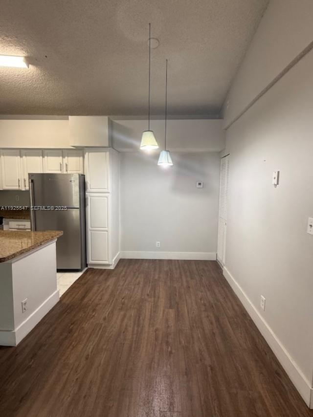 921 Lyons Road, Unit 3205 Coconut Creek, FL 33063 - Photo 8 of 37 a view of a room with wooden floor and electronic appliances