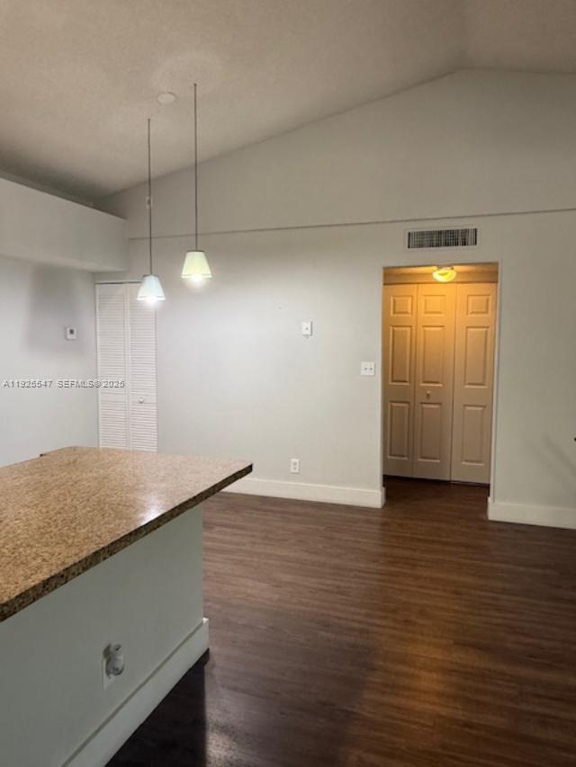 921 Lyons Road, Unit 3205 Coconut Creek, FL 33063 - Photo 9 of 37 a view of a room with wooden floor and white walls
