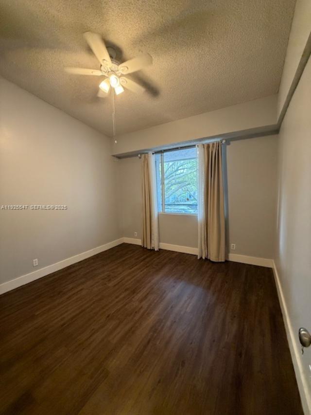 921 Lyons Road, Unit 3205 Coconut Creek, FL 33063 - Photo 10 of 37 a view of an empty room with wooden floor and a window