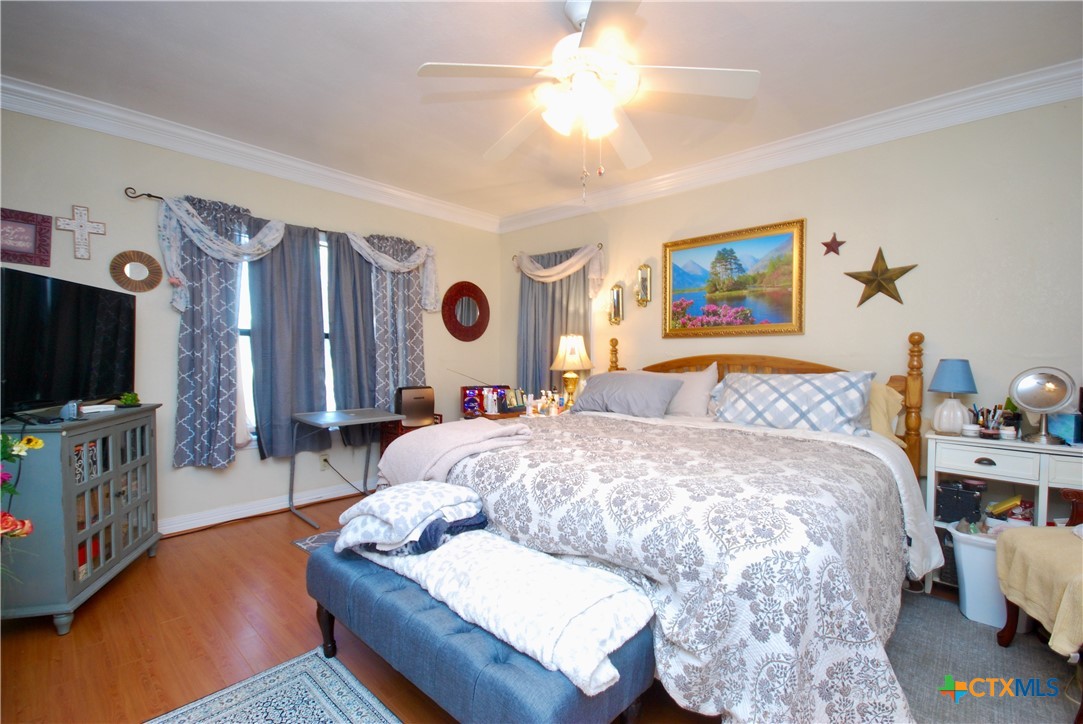 302 South Main Street Schulenburg, TX 78956 - Photo 11 of 39 a bedroom with a bed and flat screen tv