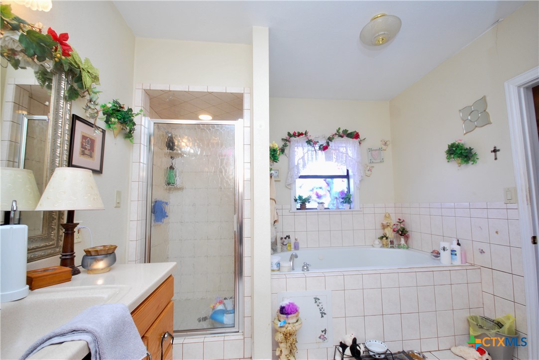 302 South Main Street Schulenburg, TX 78956 - Photo 13 of 39 a bathroom with a sink mirror and vanity