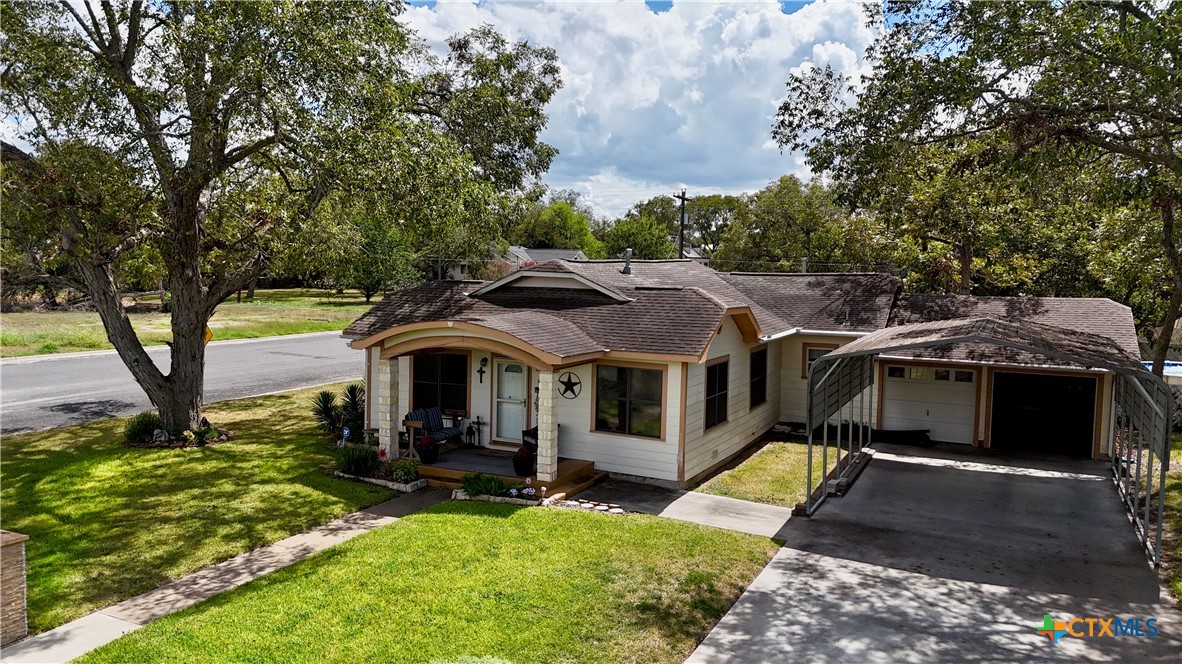 302 South Main Street Schulenburg, TX 78956 - Photo 2 of 39 a front view of a house with garden