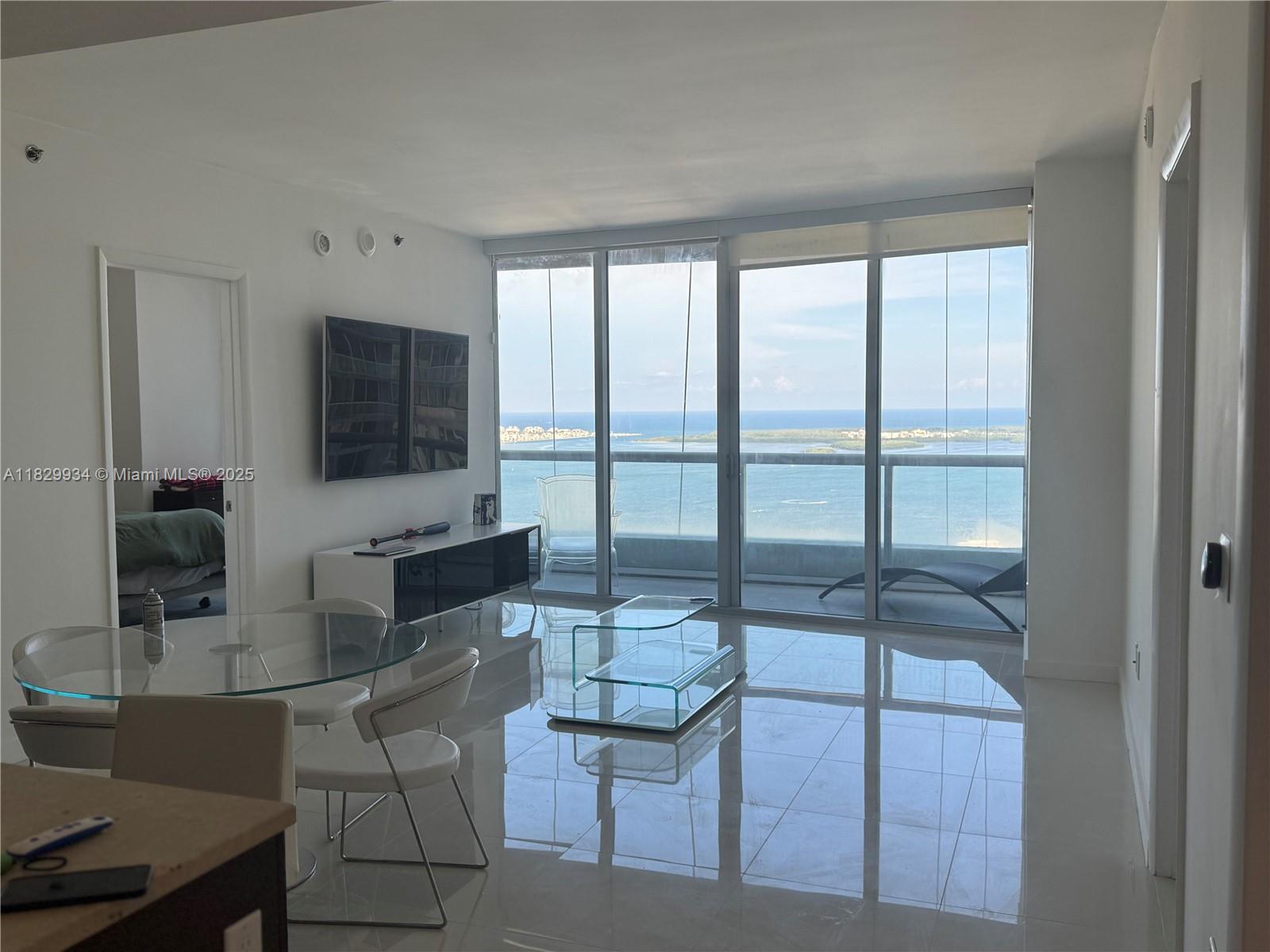475 Brickell Avenue, Unit 4207 Miami, FL 33131 - Photo 5 of 26 a living room with furniture and a flat screen tv