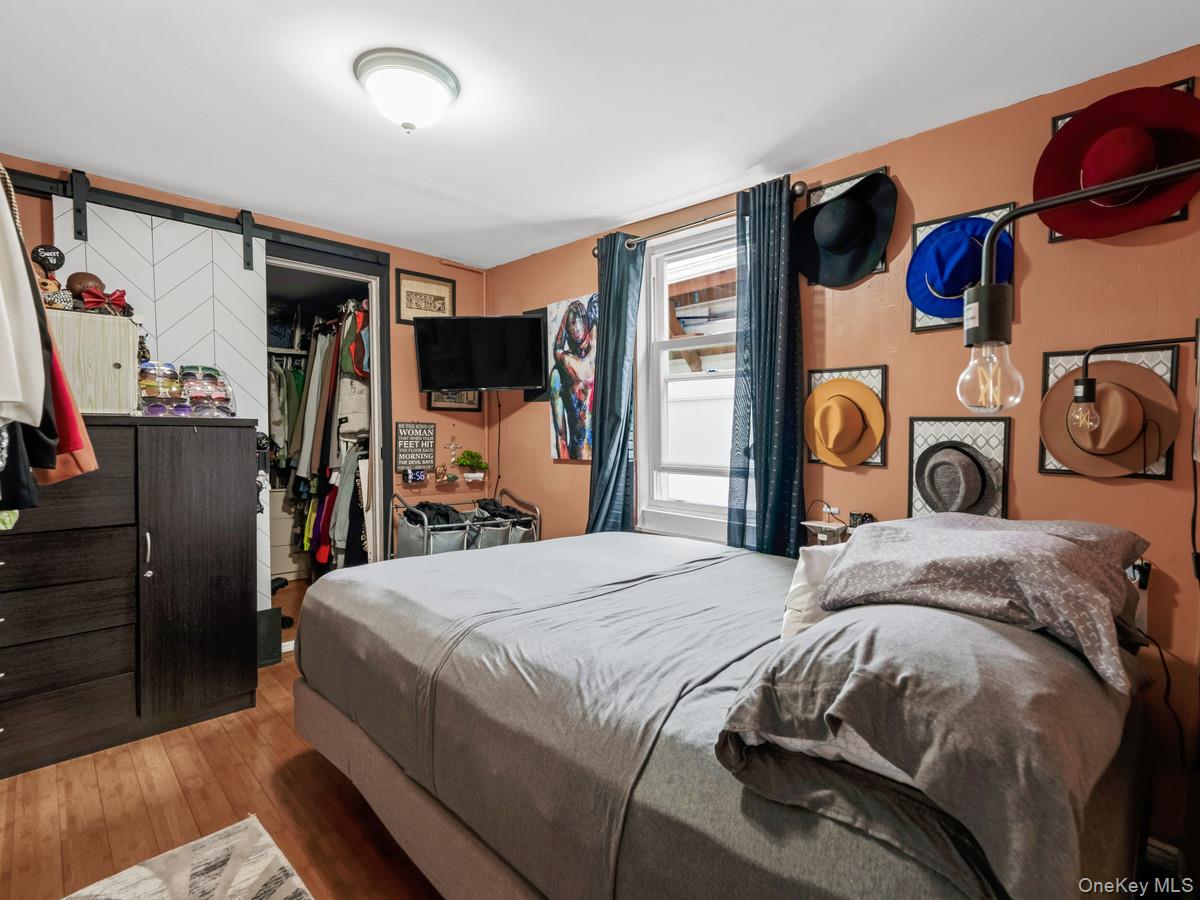 218-12 141st Road Queens, NY 11413 - Photo 6 of 14 a bedroom with a bed and a closet