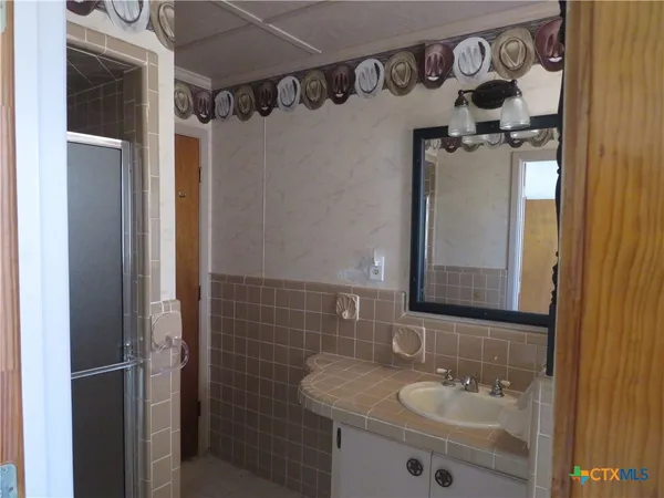 a bathroom with a sink and mirror