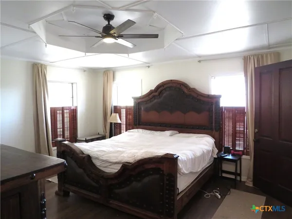 a bedroom with a bed and a chandelier