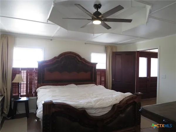 a bedroom with a bed and a chandelier