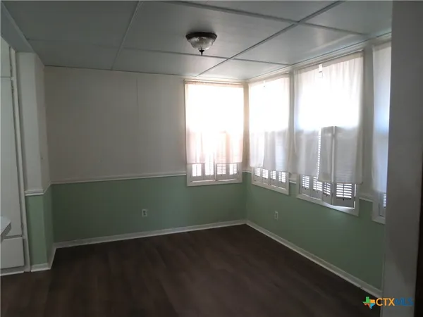 a room with wooden floors and a window