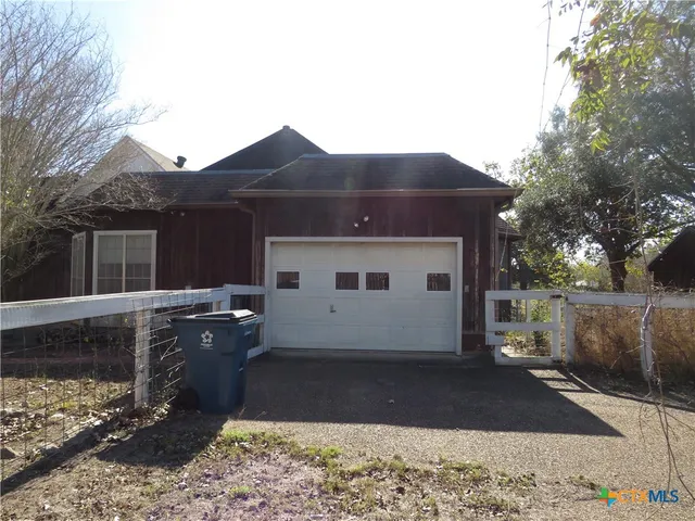 a backyard of a house with a yard and outdoor seating