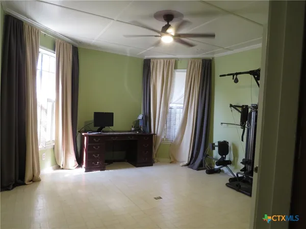 a view of room with workspace and windows