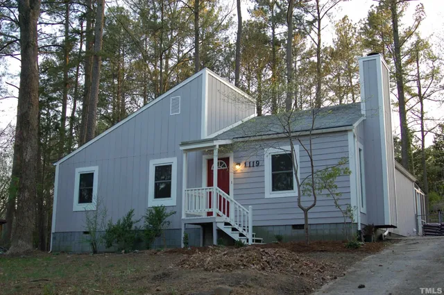 a house that has a tree in the yard