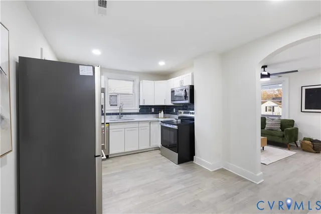 a kitchen with granite countertop a stove and a sink