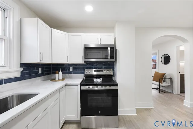a kitchen with a refrigerator and a sink