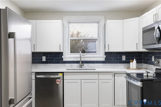 a view of a workspace with furniture and window
