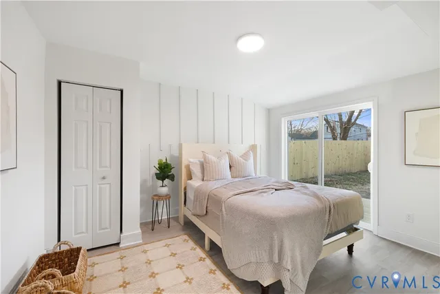 a bedroom with a large bed and a large mirror