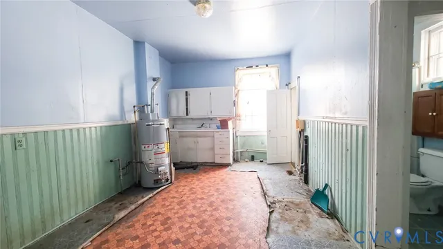 an empty room with window and wooden floor
