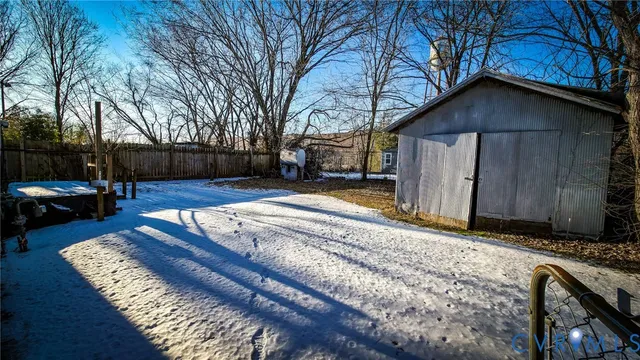a view of a house with a yard covered with snow in front of house