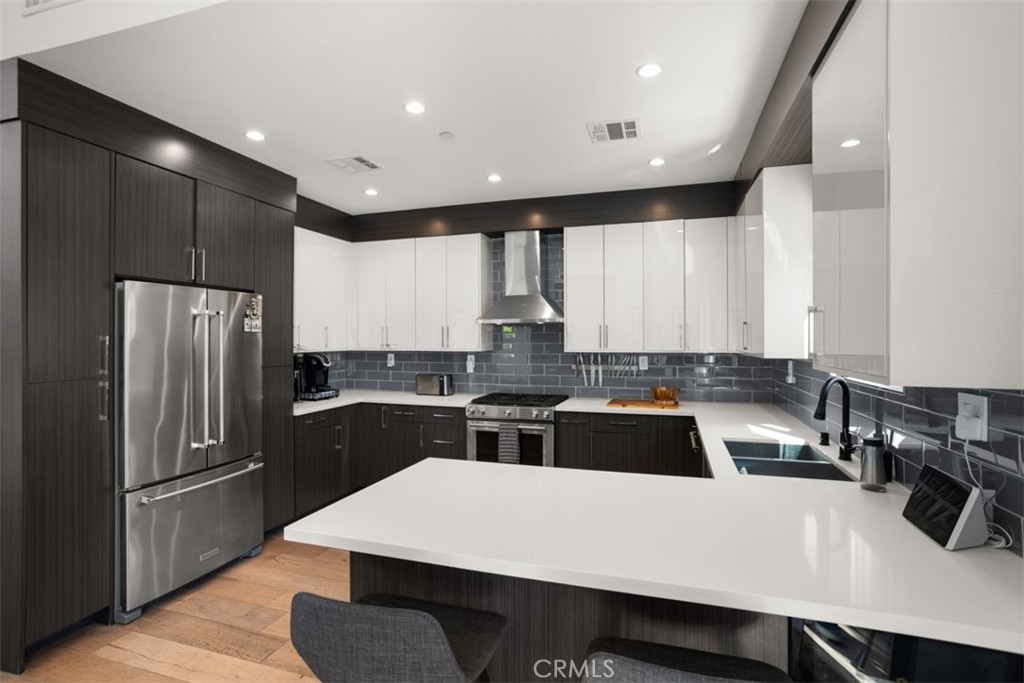 950 El Paso Drive Los Angeles, CA 90042 - Photo 20 of 52 a kitchen with a refrigerator a stove a sink and a counter