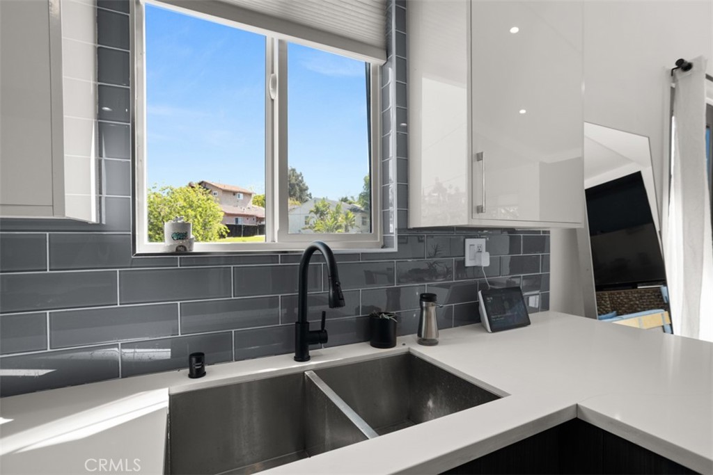 950 El Paso Drive Los Angeles, CA 90042 - Photo 21 of 52 a kitchen with a sink and a refrigerator