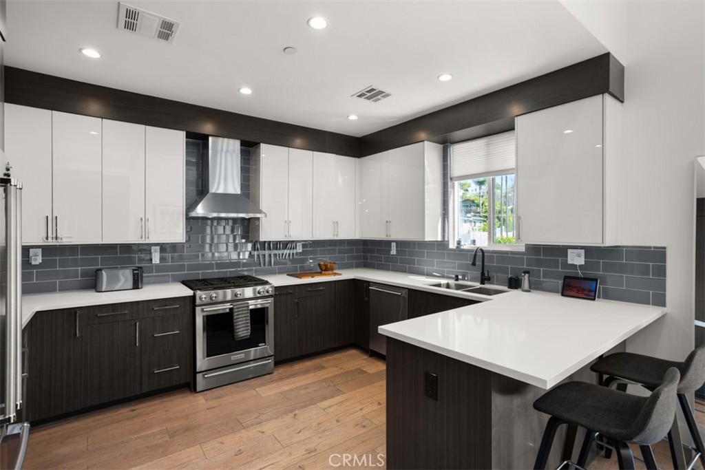 950 El Paso Drive Los Angeles, CA 90042 - Photo 3 of 52 a kitchen with stainless steel appliances kitchen island granite countertop a sink a stove top oven a counter space and cabinets