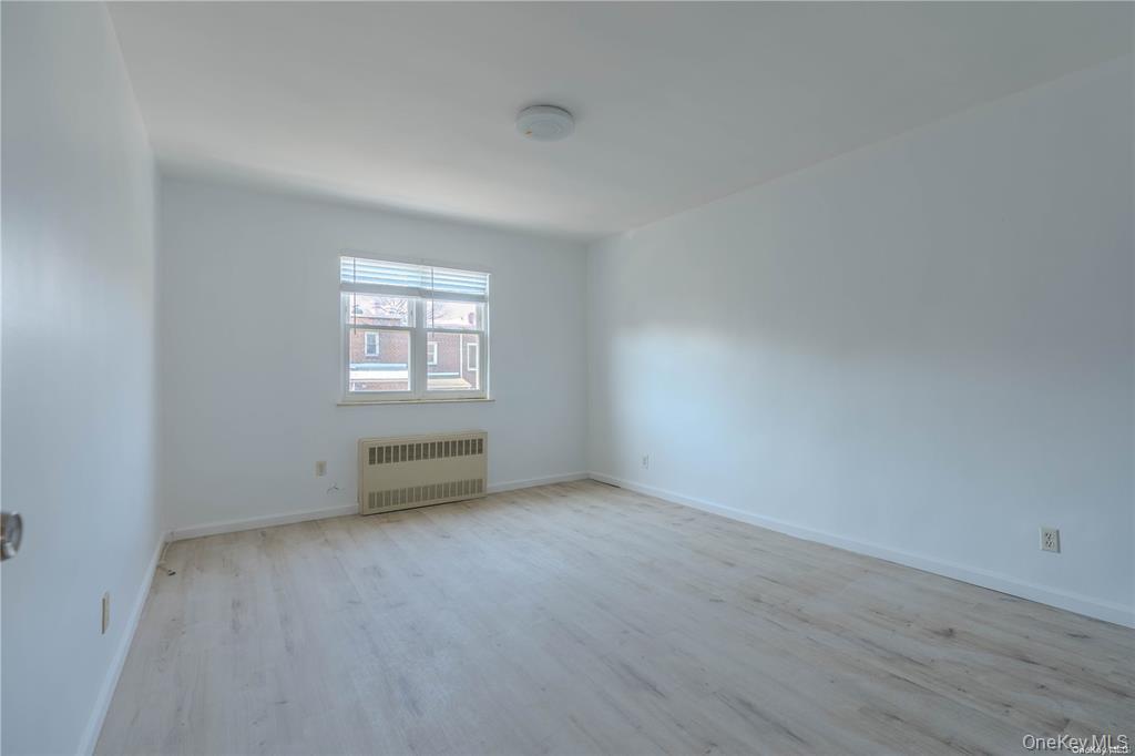 79-18 150th Street, Unit 3 Queens, NY 11367 - Photo 5 of 10 an empty room with windows
