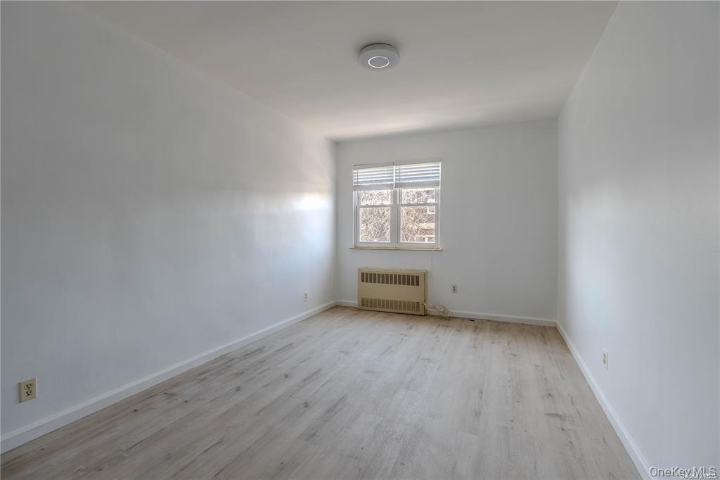 79-18 150th Street, Unit 3 Queens, NY 11367 - Photo 6 of 10 an empty room with a window