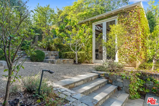 a view of a chairs and table in backyard