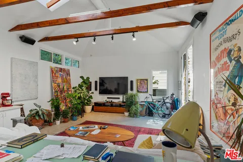 a living room with furniture potted plant and a flat screen tv