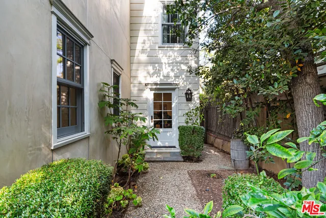 a spacious bedroom with a bed and a chandelier