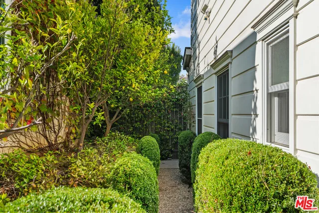 a bathroom with a sink and mirror with shower
