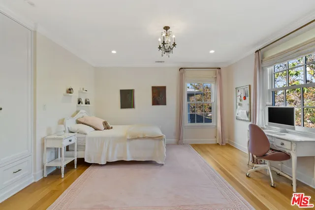 a bed room with a bed and a book shelf