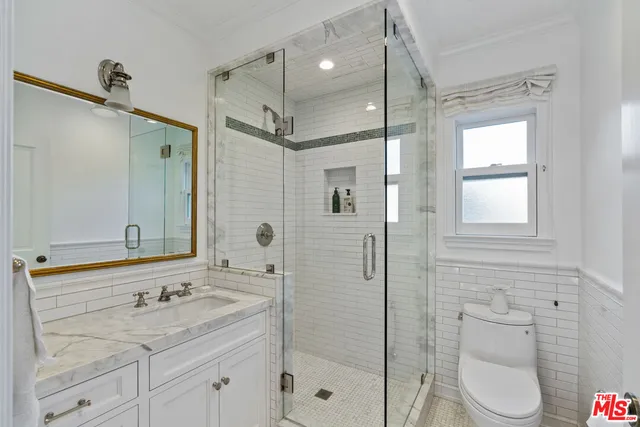 a spacious bedroom with a bed and a chandelier