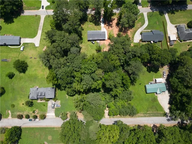 an aerial view of a house with a yard and lake view