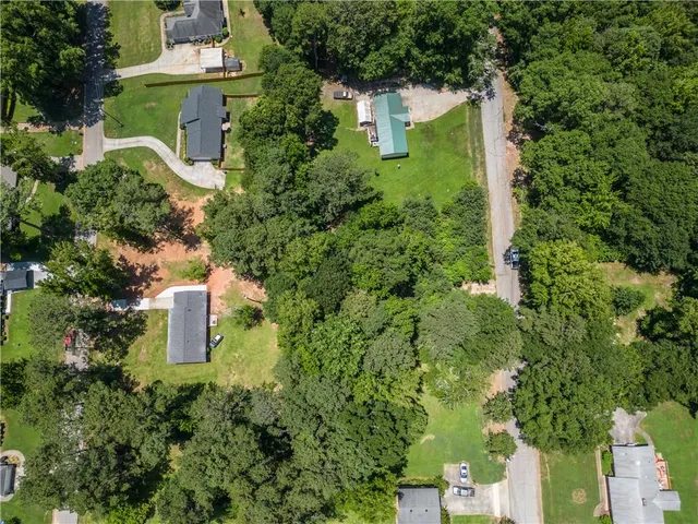 an aerial view of a house with a yard and trees