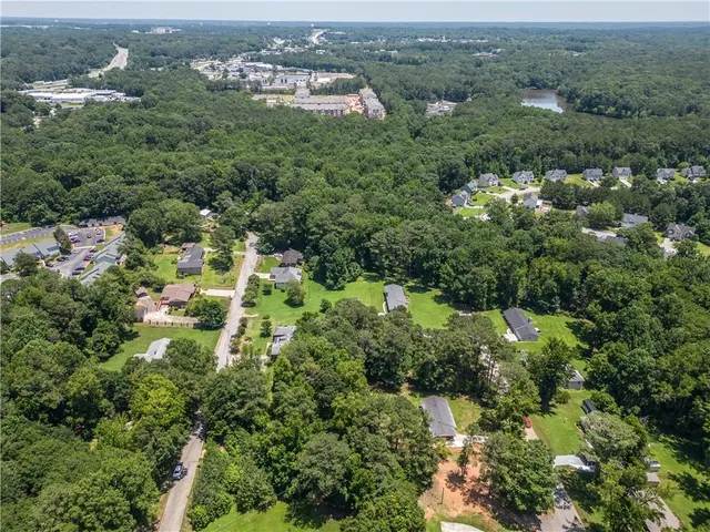 an aerial view of a houses with a yard