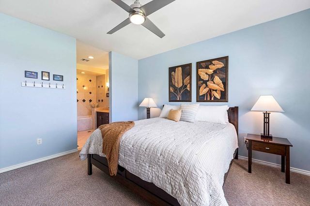 a bathroom with a tub a sink double vanity and a mirror
