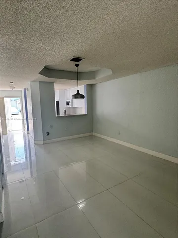 a view of a livingroom with a ceiling fan and window