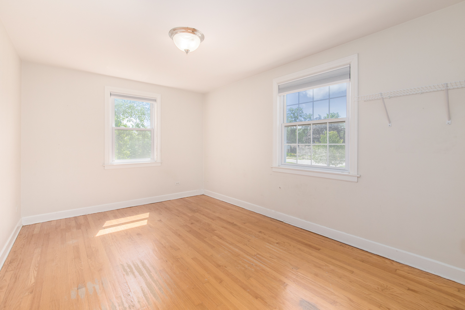 516 Engel Boulevard Park Ridge, IL 60068 - Photo 39 of 51 an empty room with wooden floor and windows
