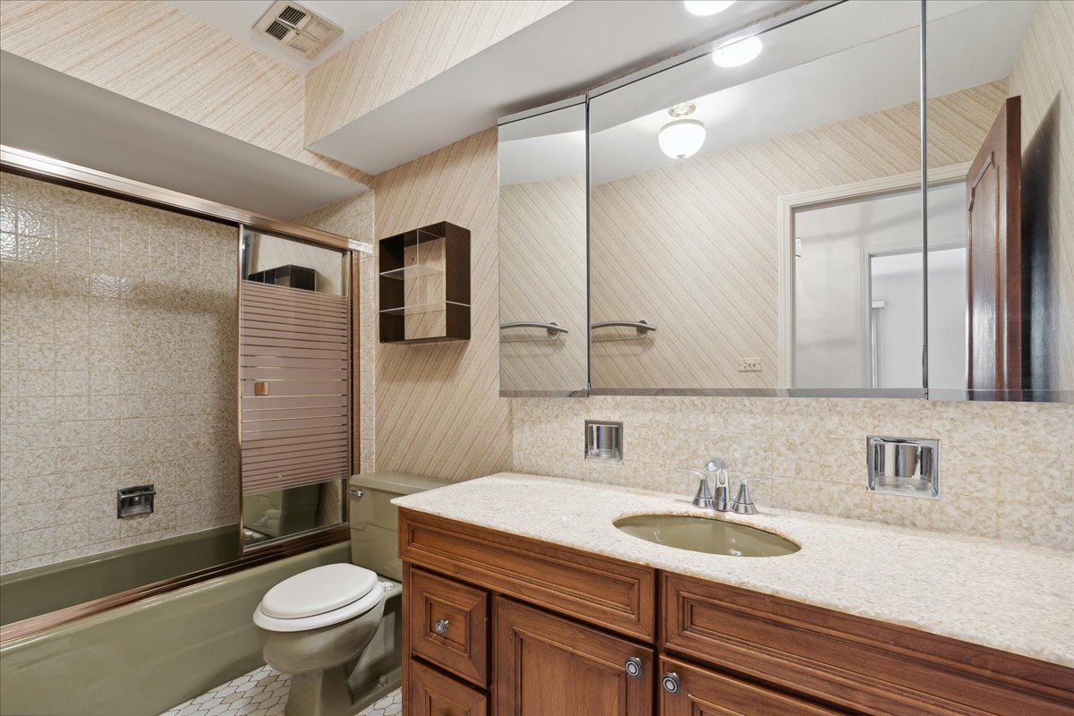962 Suffield Terrace Northbrook, IL 60062 - Photo 16 of 33 a bathroom with a sink toilet double vanity and shower