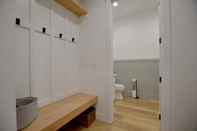 a bathroom with a tub sink double vanity and mirror