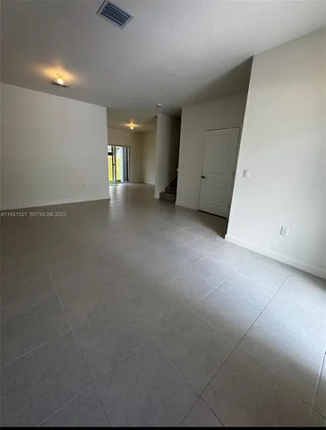a view of a kitchen with a sink and cabinets
