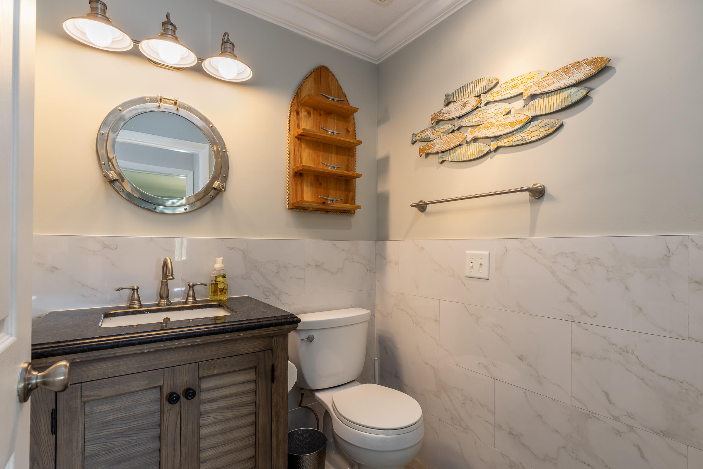 98222 Windward Avenue Key Largo, FL 33037 - Photo 27 of 41 a bathroom with a toilet a sink and mirror