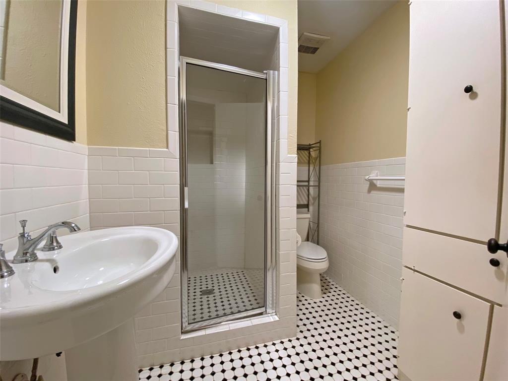 7406 Walling Lane Dallas, TX 75231 - Photo 12 of 15 a bathroom with a sink toilet and shower